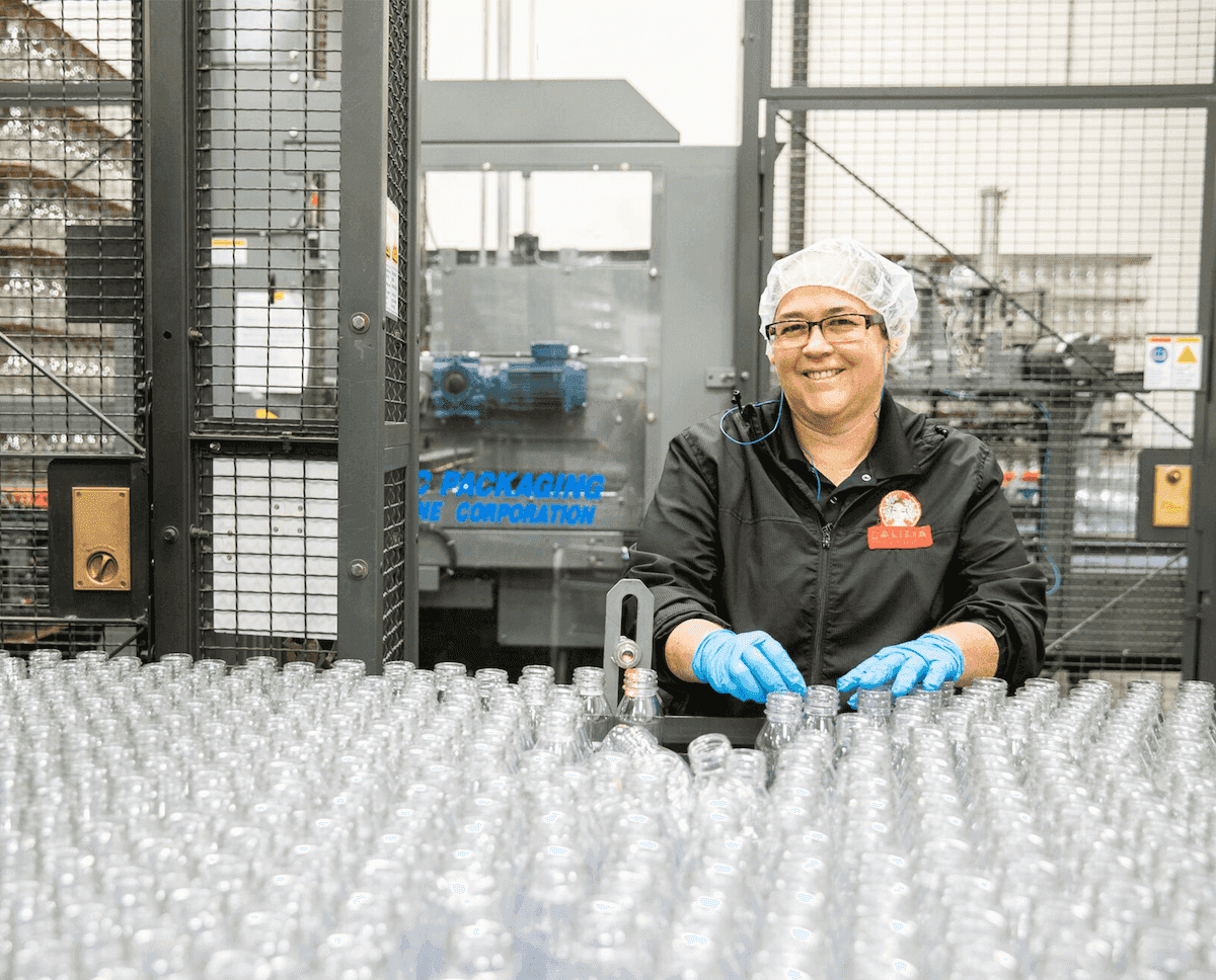 A woman working in a bottling factory
